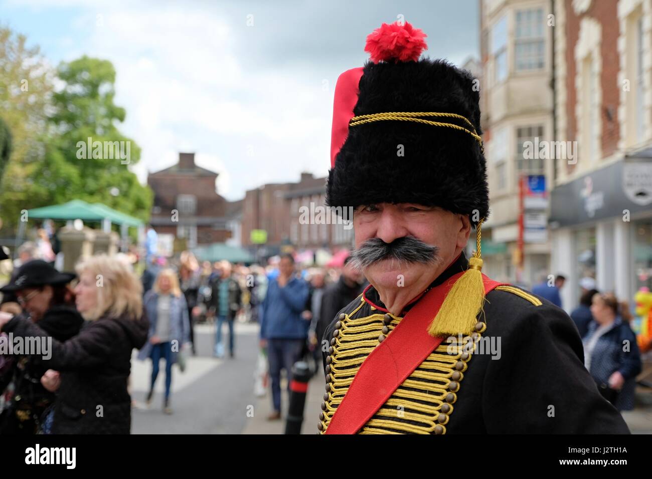 Blandford Forum, Dorset, UK. 1 May 2017. Crowds dodge the showers at Blandford Forum May Day Georgian Fayre where  up to 30,000 people, many in Georgian dress attended the largest Georgian event in the South of England Credit: Tom Corban/Alamy Live News Stock Photo
