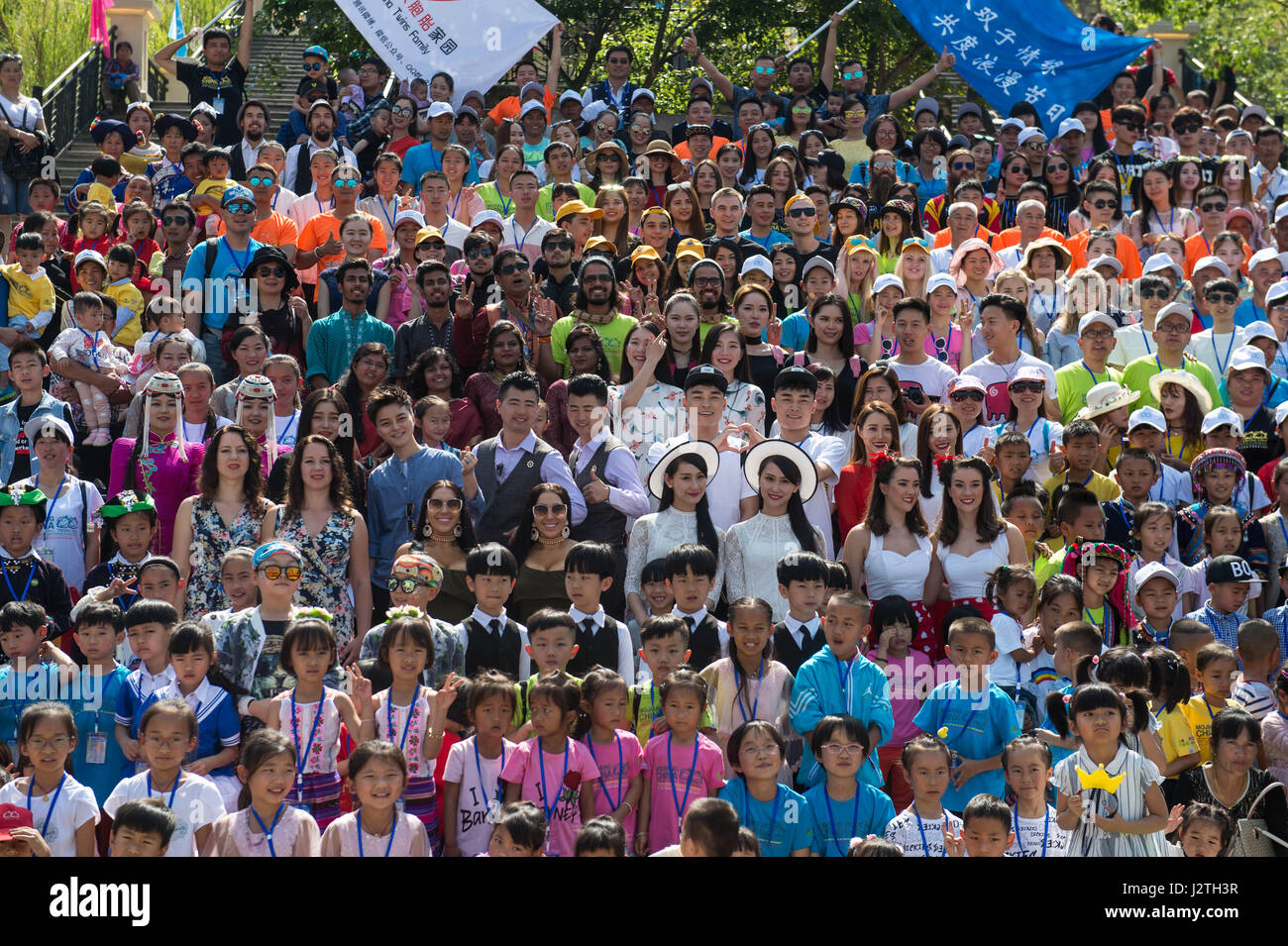 (170501) -- MOJIANG, May 1, 2017 (Xinhua) -- People pose for a group photo during an annual twins festival in Mojiang, southwest China's Yunnan Province, May 1, 2017. Twins and multiple births from home and abroad gathered here to celebrate the three-day festival. Mojiang County is known in China as 'the land of twins' because the county has more than 1,000 pairs of twins. (Xinhua/Hu Chao)(mcg) Stock Photo