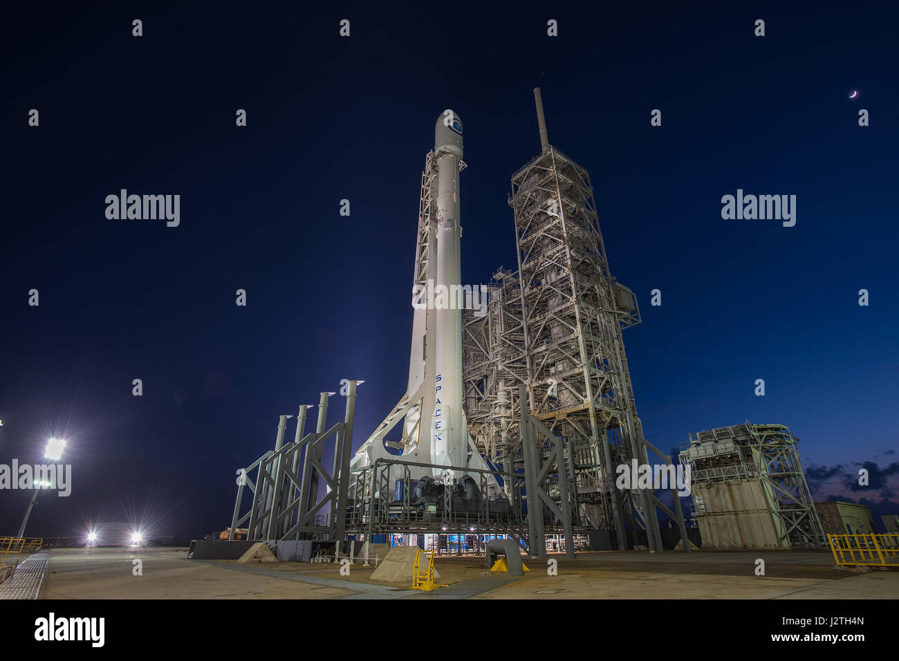 The SpaceX Falcon 9 rocket carrying a classified military satellite sits on Launch Complex 39A ready for blast off at the Kennedy Space Center late April 29, 2017 in Cape Canaveral, Florida. The SpaceX mission was scrubbed at the last minute due to a faulty sensor and will try again on May 1st. Stock Photo