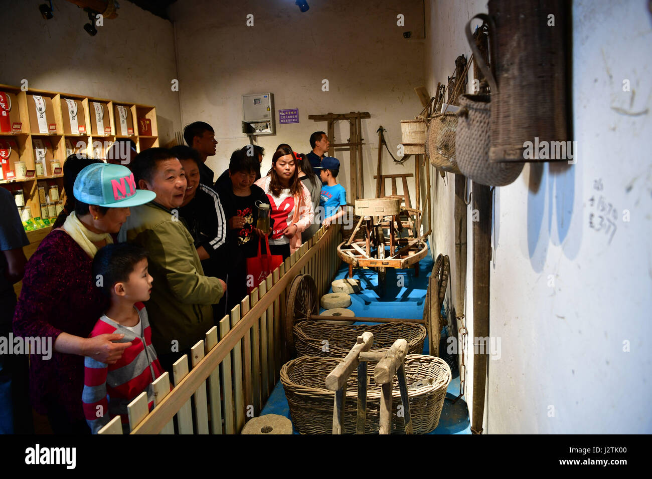 Zhengzhou, China's Henan Province. 1st May, 2017. Tourists visit an exhibition of traditional farming tools in Sangyuan Village of Hebi City, central China's Henan Province, May 1, 2017. Rural tourism maintained robust growth in China last year as more city-dwellers prefer a taste of the country life during holidays, and governments hope the burgeoning sector will help relieve poverty. Credit: Feng Dapeng/Xinhua/Alamy Live News Stock Photo