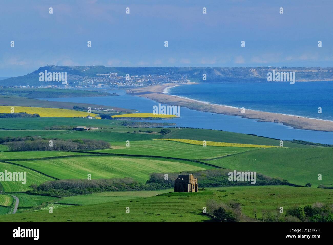 Abbotsbury, Dorset, UK. 1st May, 2017. After a day of changable weather the Dorset countryside is lit with the late afternoon sun showing St Catherine's Chapel in the foreground in front of Chesil Beach with the island of Portland in the background. Credit: Tom Corban/Alamy Live News Stock Photo