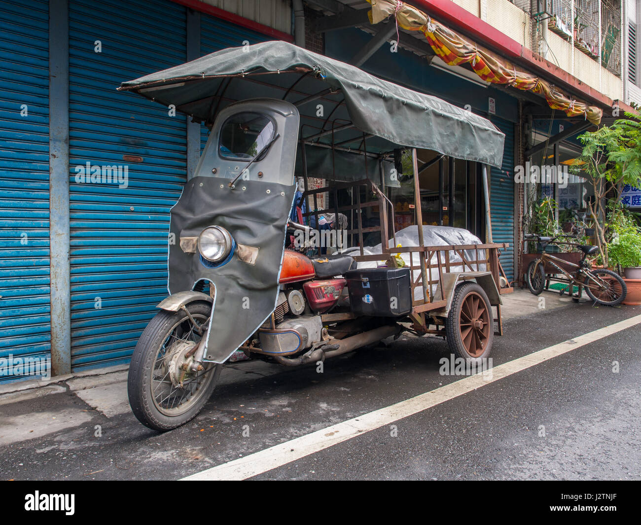 Taipei, Taiwan - October 16, 2016: A Motorbike  with a large trunk for transporting goods Stock Photo