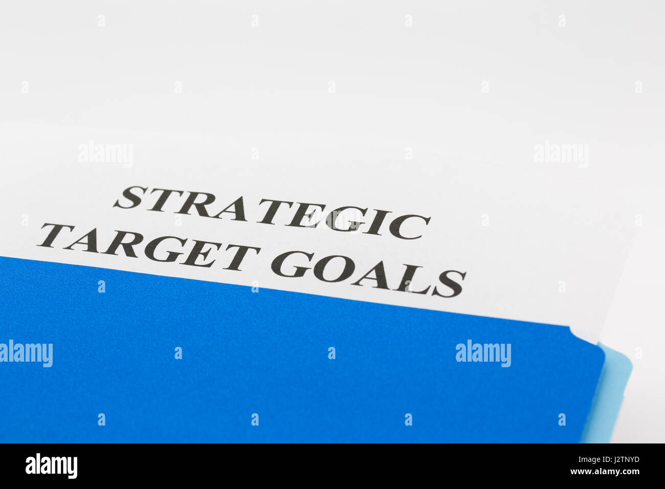Blue file folder with Strategic Target Goals report cover slipped out.  Horizontal photograph with copy space. Stock Photo