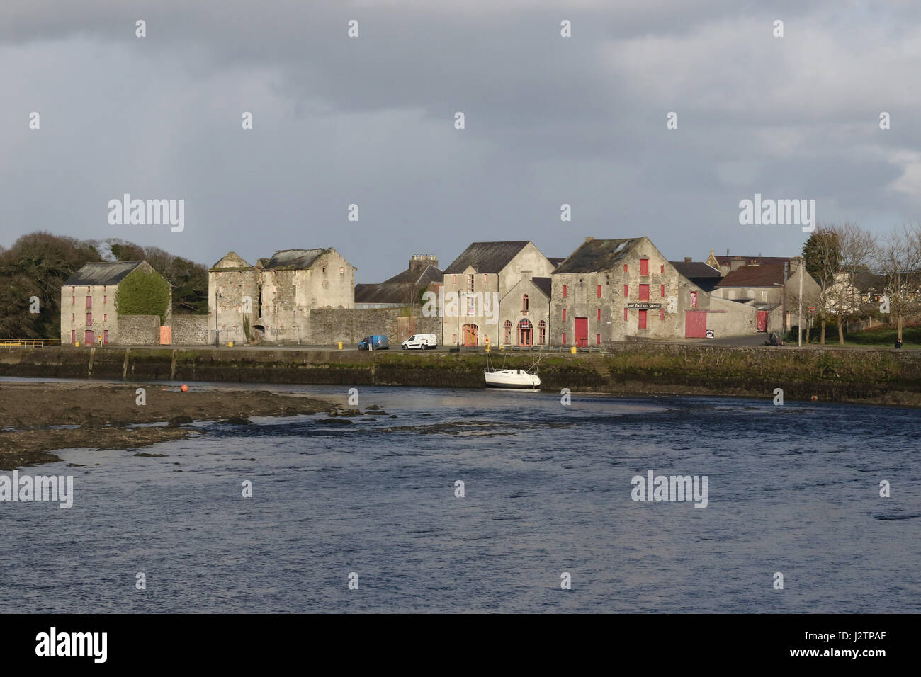 The River Lennon in Ramelton, County Donegal, Ireland, with old warehouse stores in the background. Stock Photo