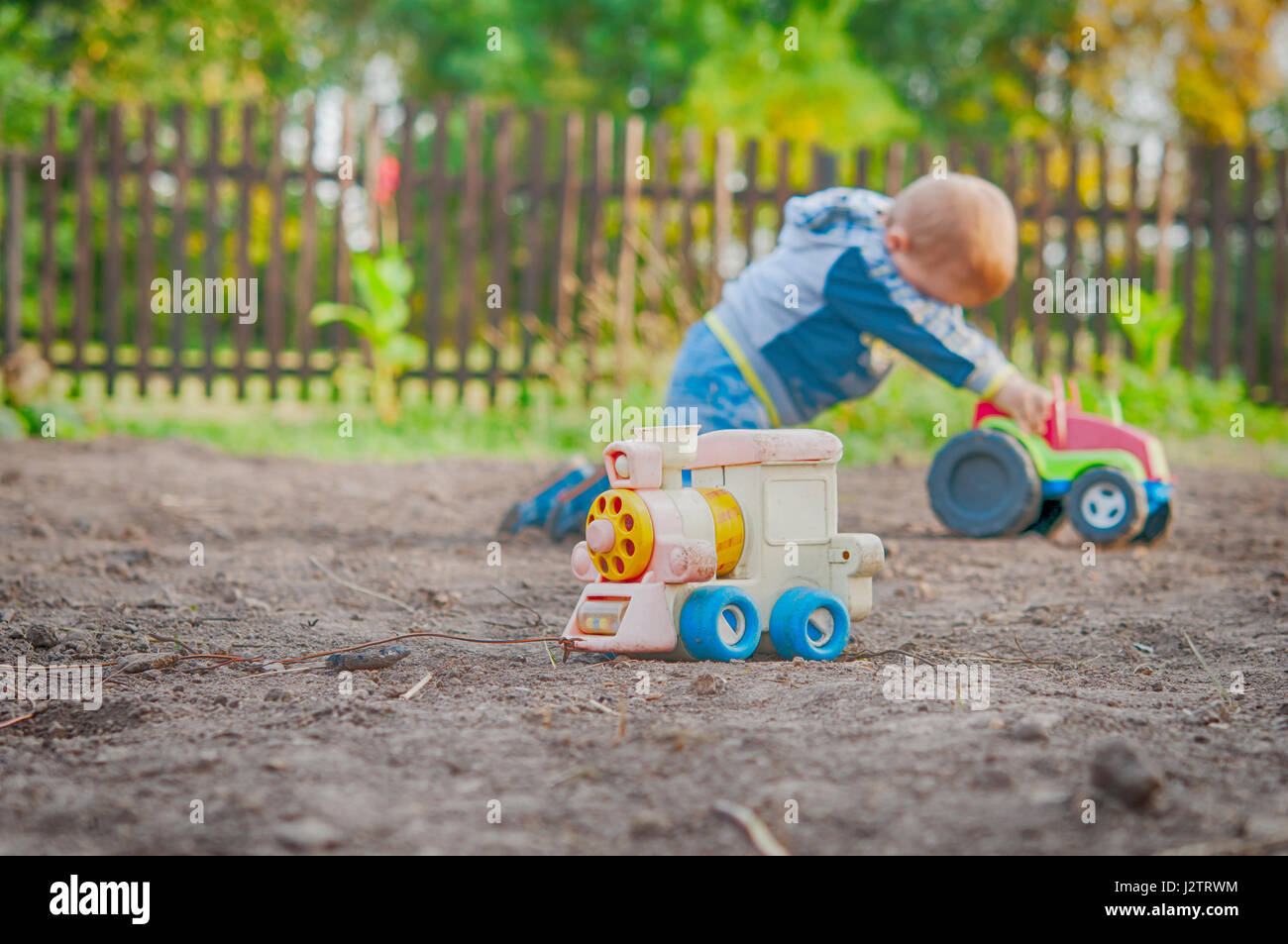 a little boy playing in the toy car in the children's village Stock Photo