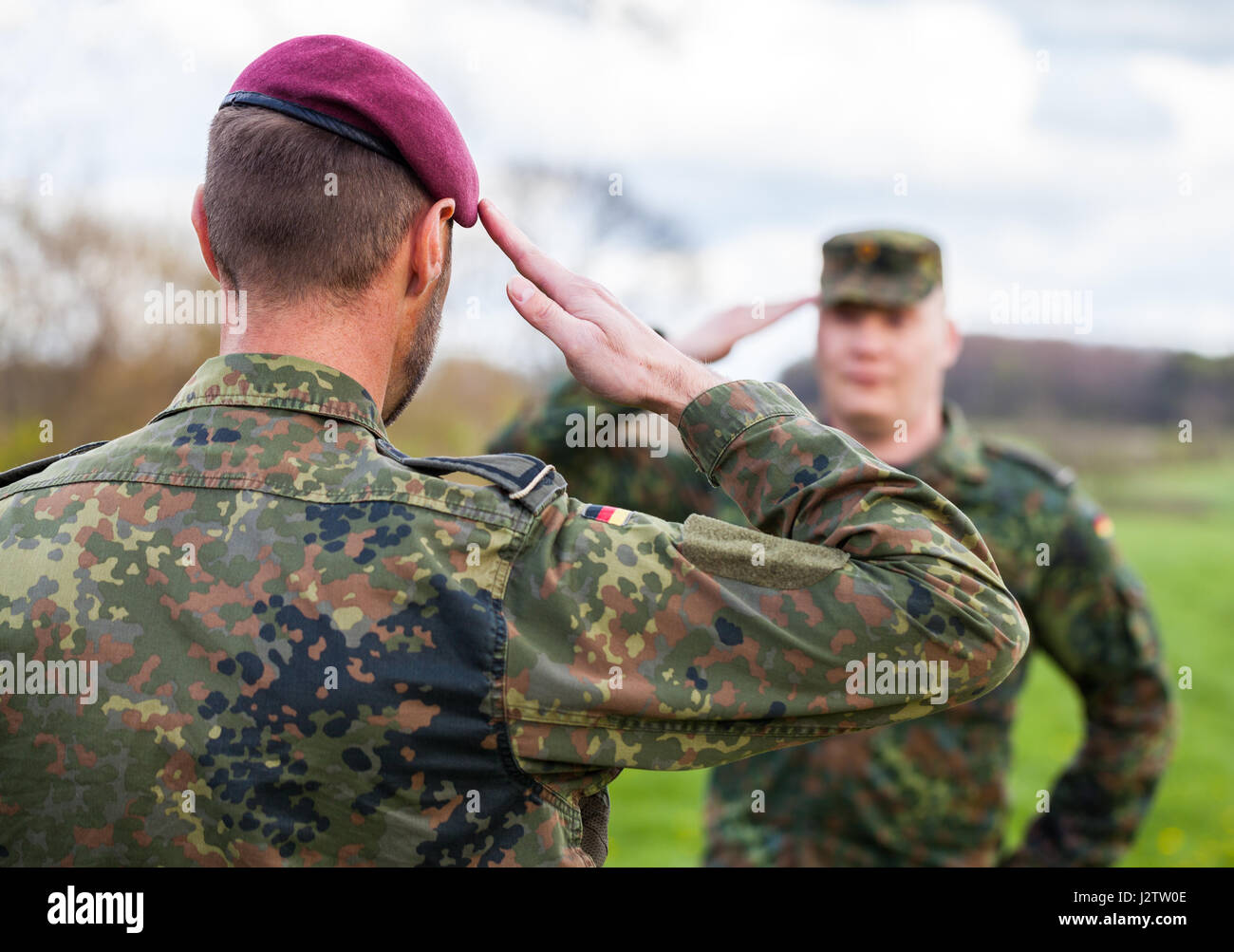 two german soldiers salute each other Stock Photo