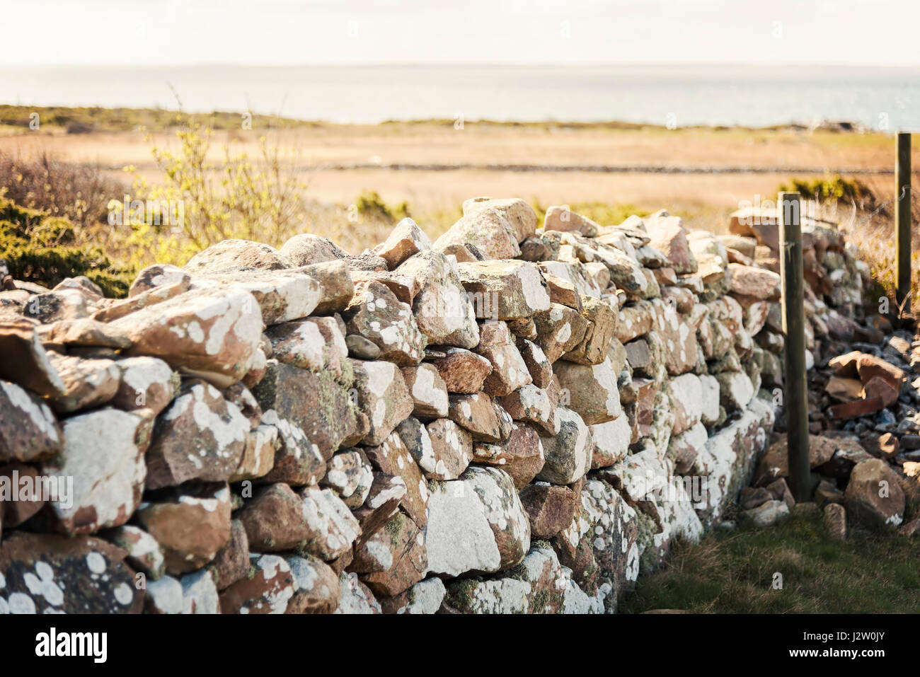 Image of natural stone wall by beach. Stock Photo