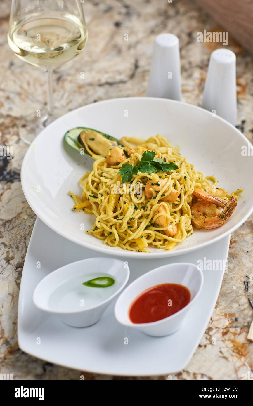 Flat egg noodles with seafood Stock Photo Alamy