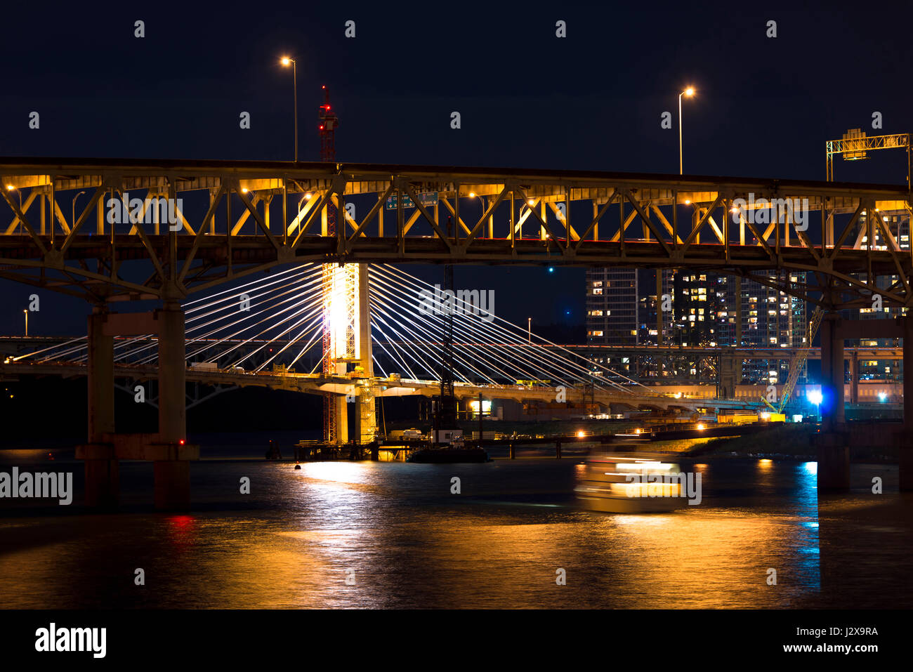 Modern rope and classic truss bridges across the evening Willamette ...