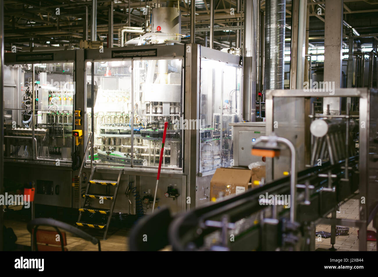 Beer production line. Equipment for the staged production and bottling of the finished product. Special industrial technological device at the factory Stock Photo