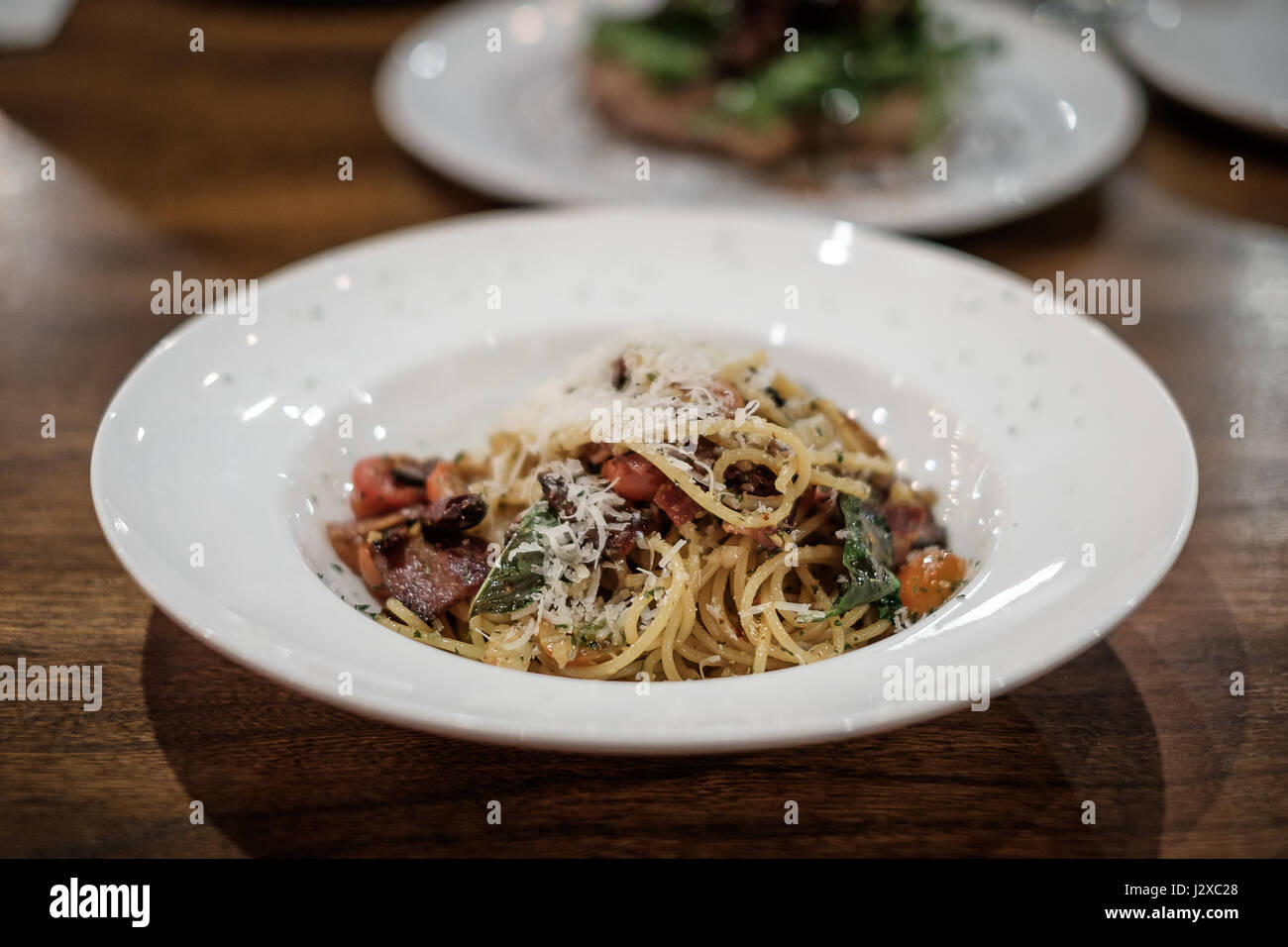 Spaghetti with olive oil, dry chili, and bacon, traditional Italian style. Stock Photo