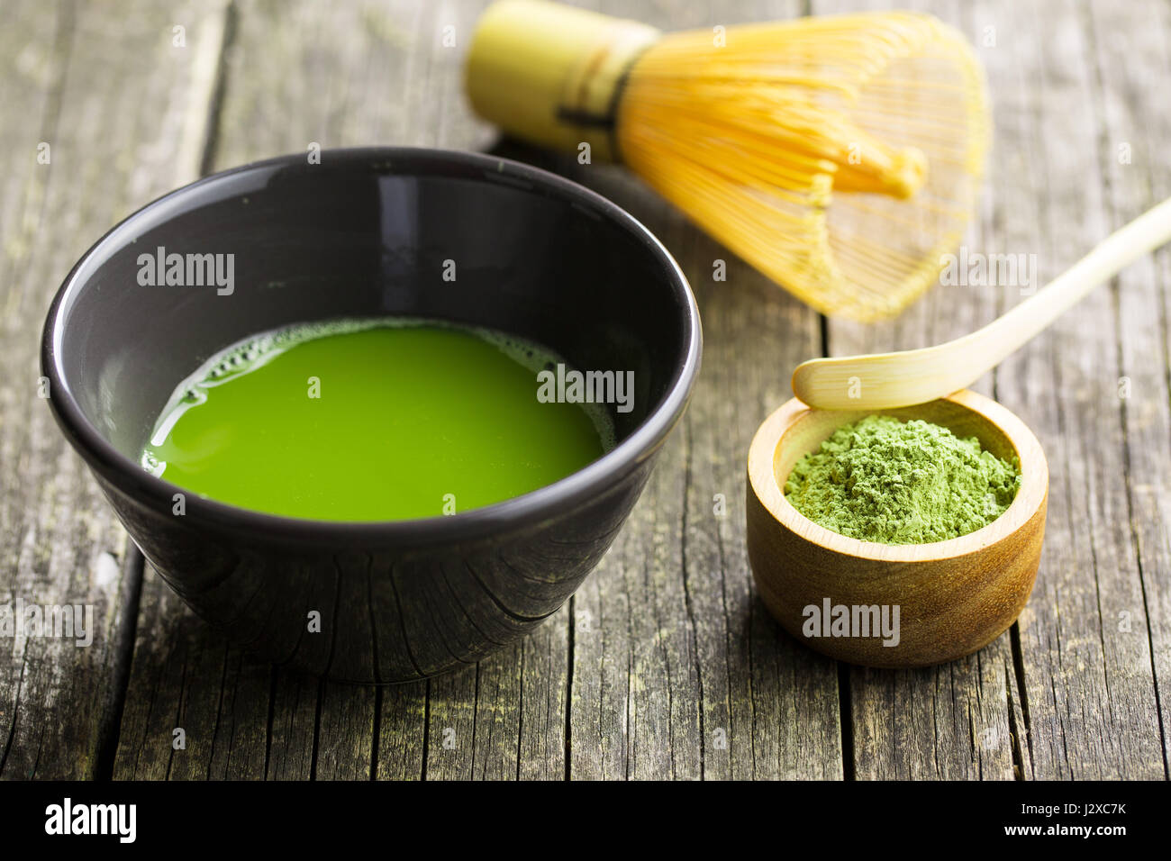 Green matcha tea , bamboo whisk, spoon and tea powder. Stock Photo