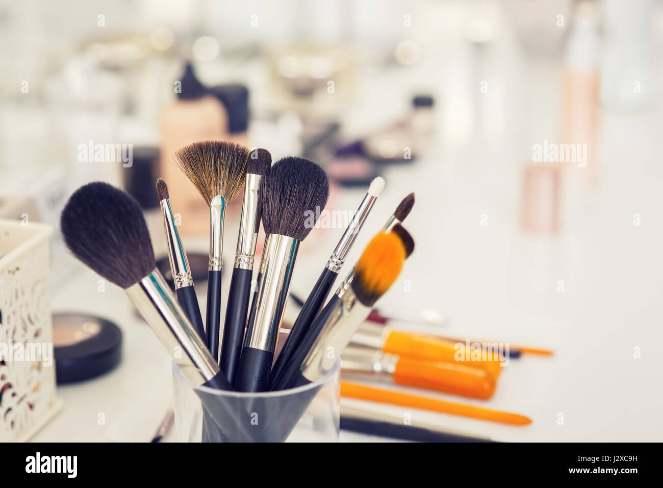 set of professional makeup brushes in glass on table closeup. Filtered photo  with selective focus and toning. Make-up table in beauty salon. Still lif  Stock Photo - Alamy