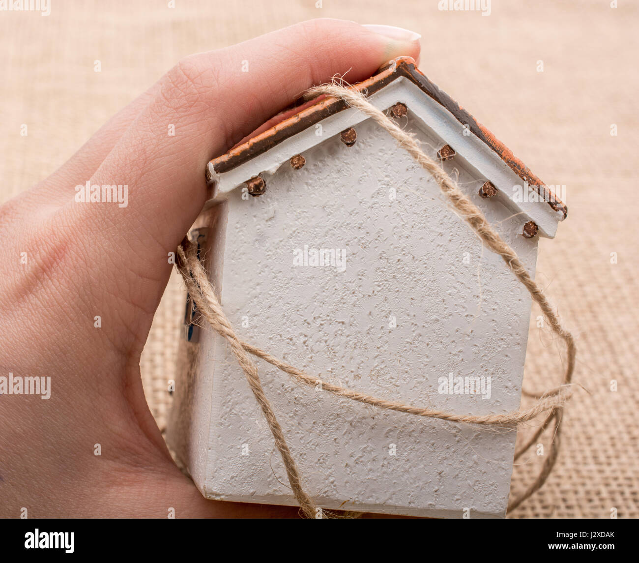 Thread wrapped around a model house on a brown background Stock Photo ...