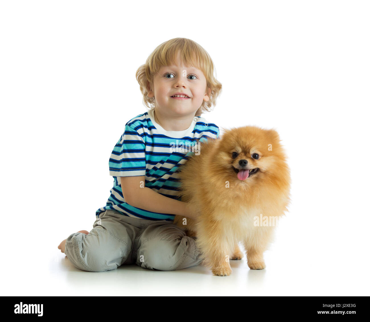 Little boy with dog spitz, isolated on white background Stock Photo