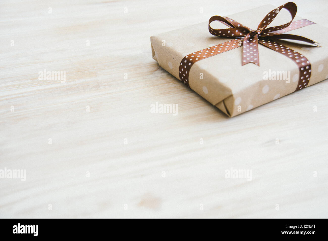 Download Box In Craft Paper Eco Paper On The Wooden Table Top View Brown Paper Wrapped Gift Box With Satin Ribbon Bow On A Old Rustic Wooden Background Bac Stock Photo Alamy