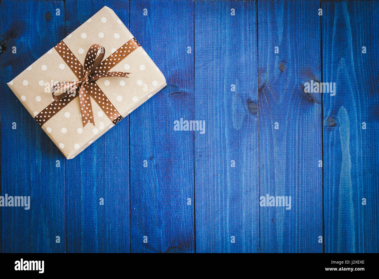 Download Box In Craft Paper Eco Paper On The Wooden Table Top View Brown Paper Wrapped Gift Box With Satin Ribbon Bow On A Old Rustic Blue Wood Background Stock Photo Alamy
