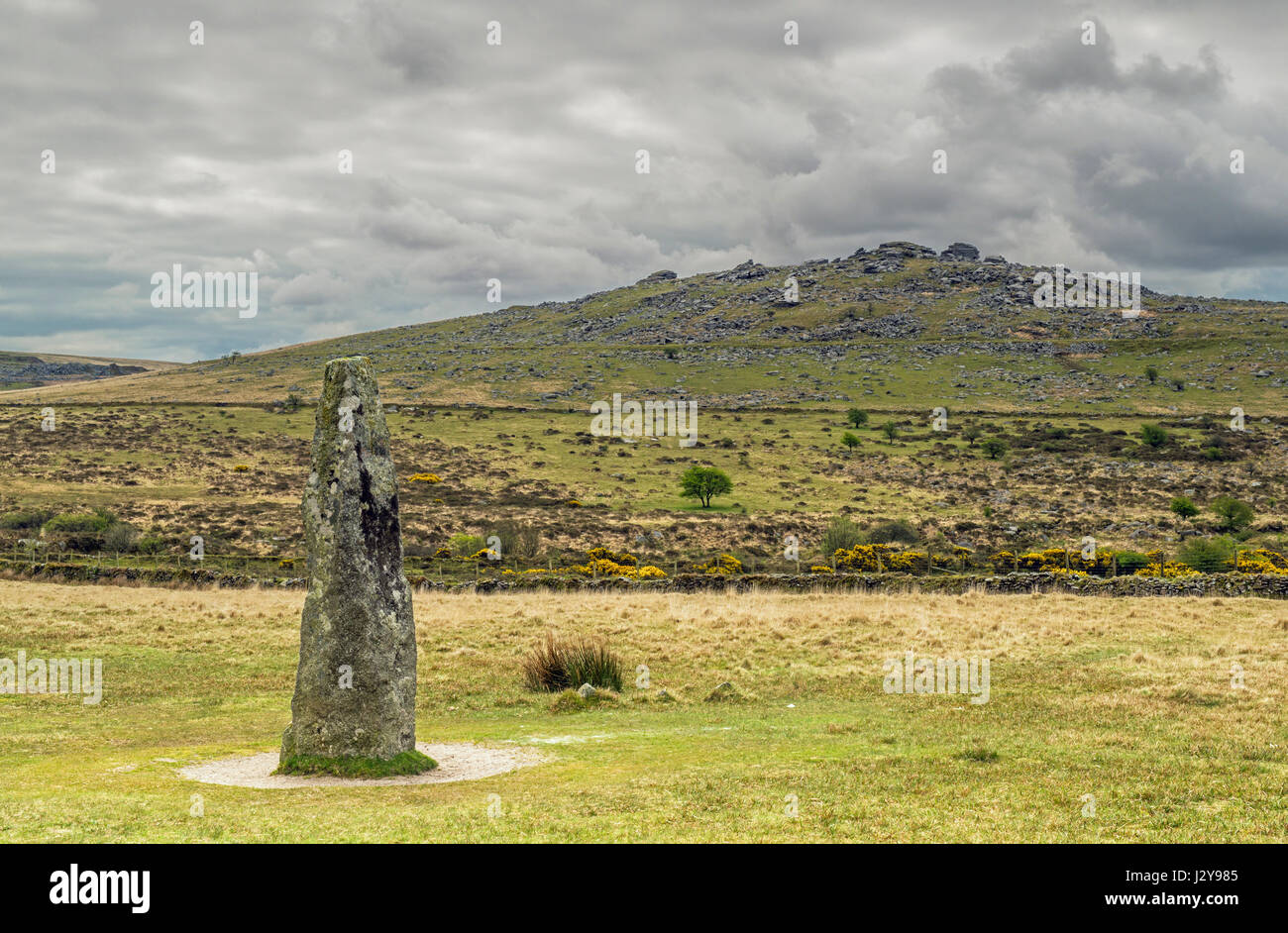 Kings Tor on Dartmoor near Merrivale with a Standing Stone in the foreground, demonstrating the history of the Moor Stock Photo