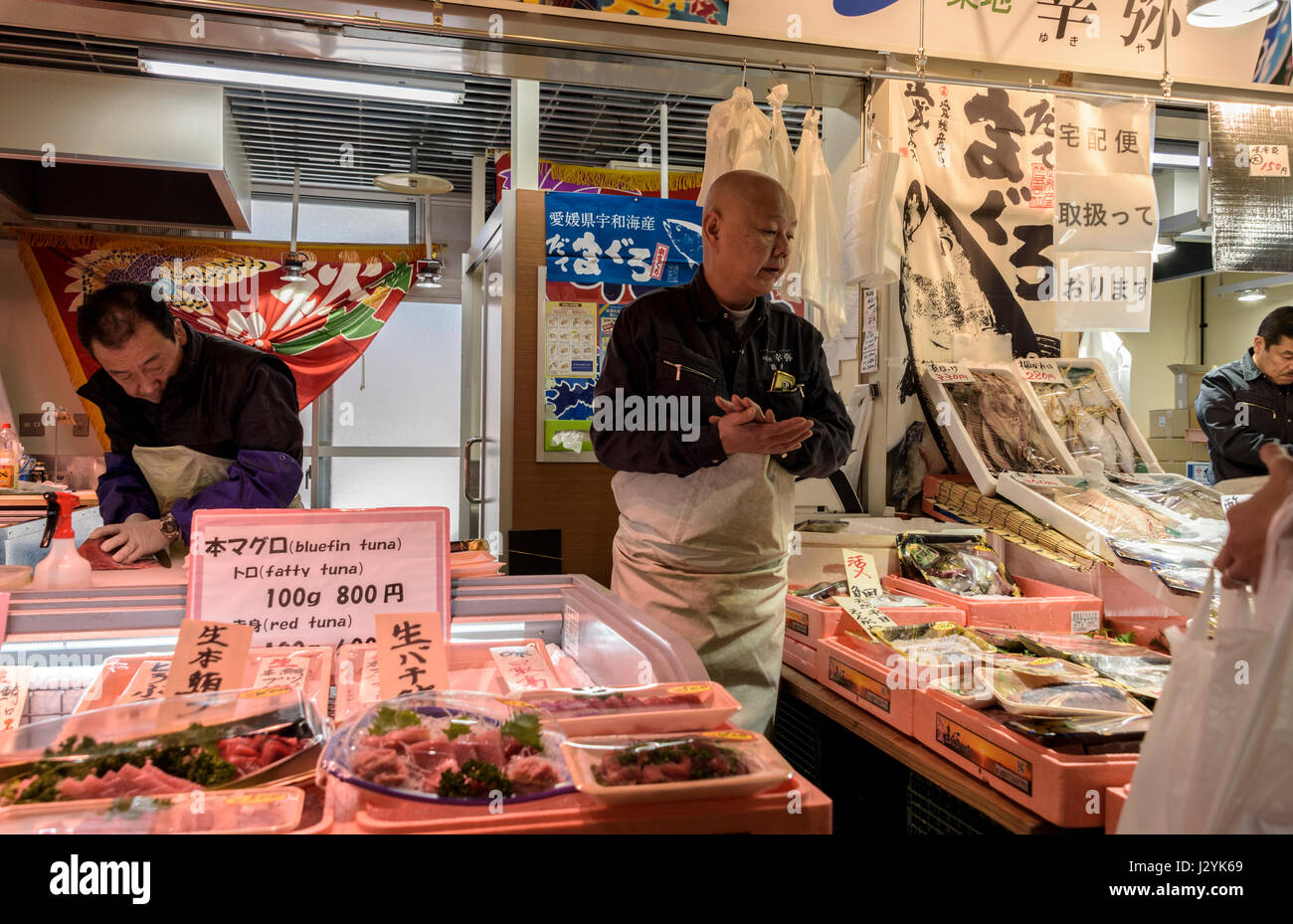 Market seller inTsukiji fish market, indoor retail market. , Tokyo. Stock Photo