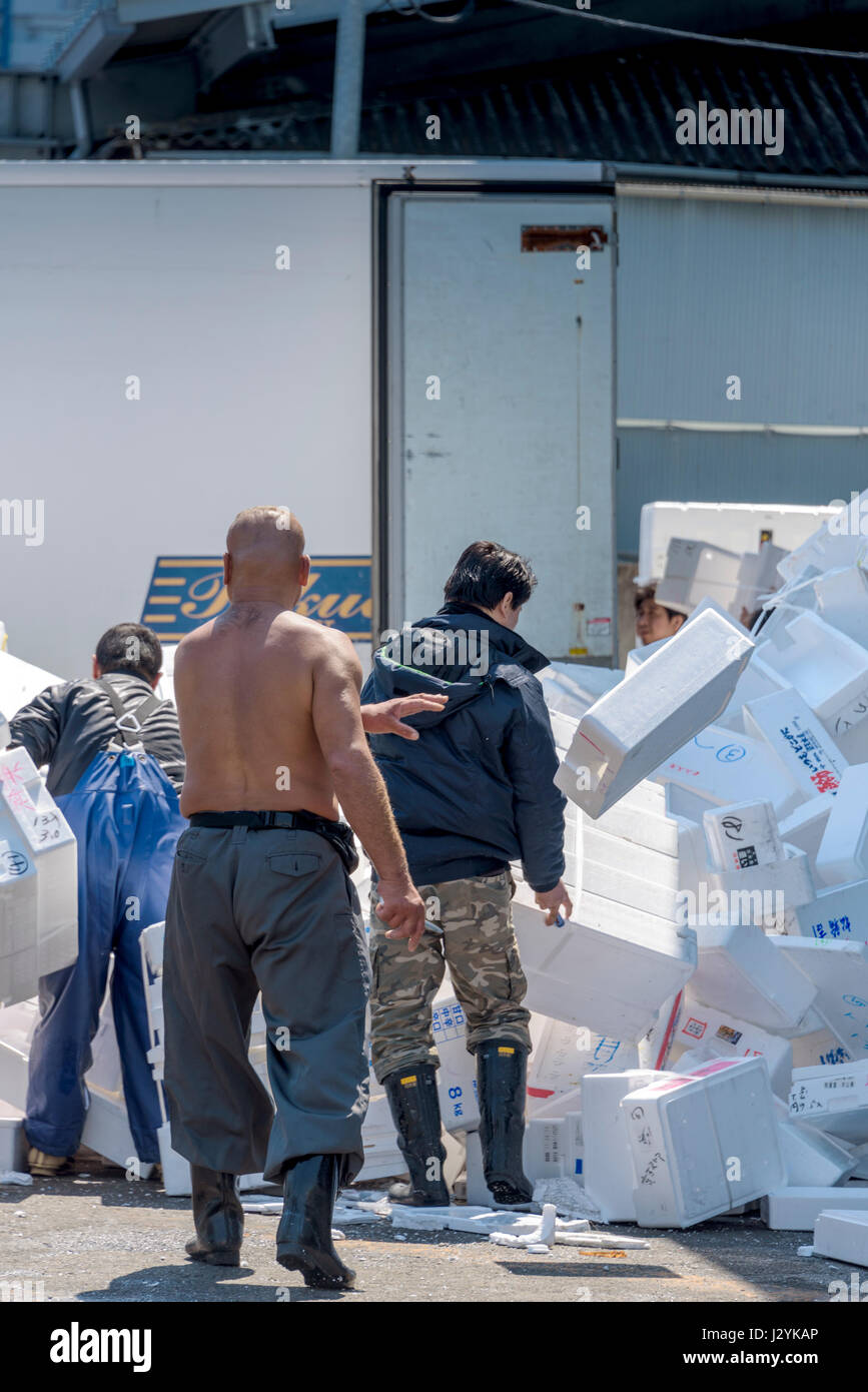 Workers clear away empty polystyrene boxes at the Tsukiji fish market being recycled. Stock Photo