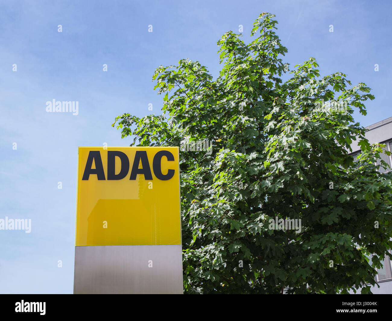 Munich, Germany - May 12, 2015: ADAC signage with German automobile club logo largest automobile association in Europe. Stock Photo