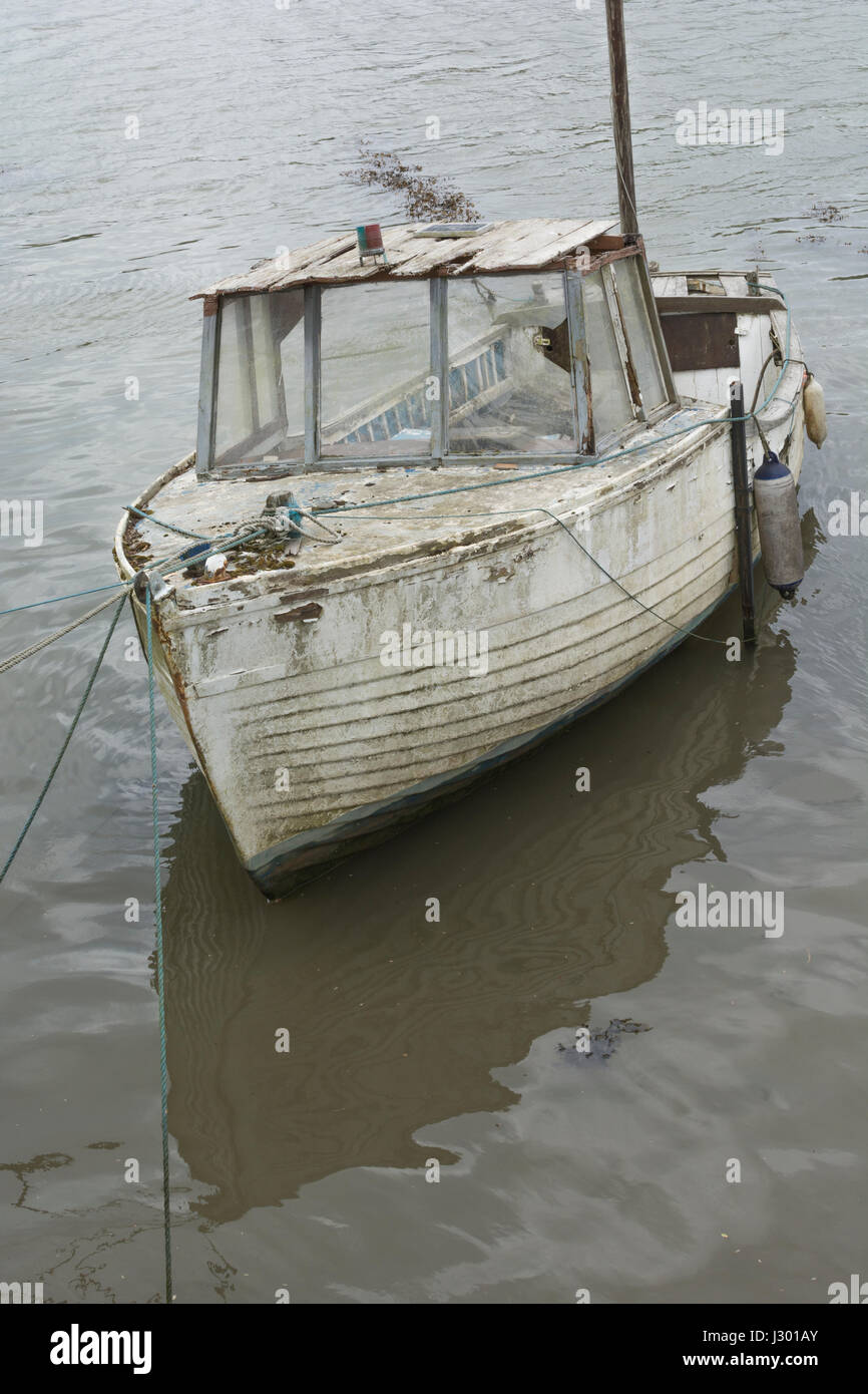 Waterlogged boat as visual metaphor for 'sinking the ship',  'sink the boat', going down with the ship, organisational failure, or crisis management. Stock Photo