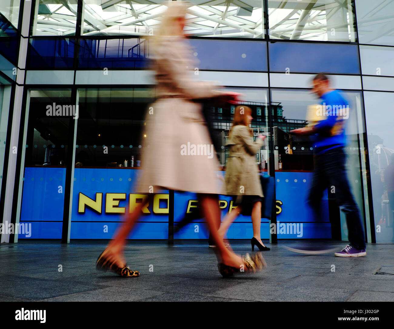 Commuters walk past a branch of Caffe Nero at Kings Cross Station in London Stock Photo