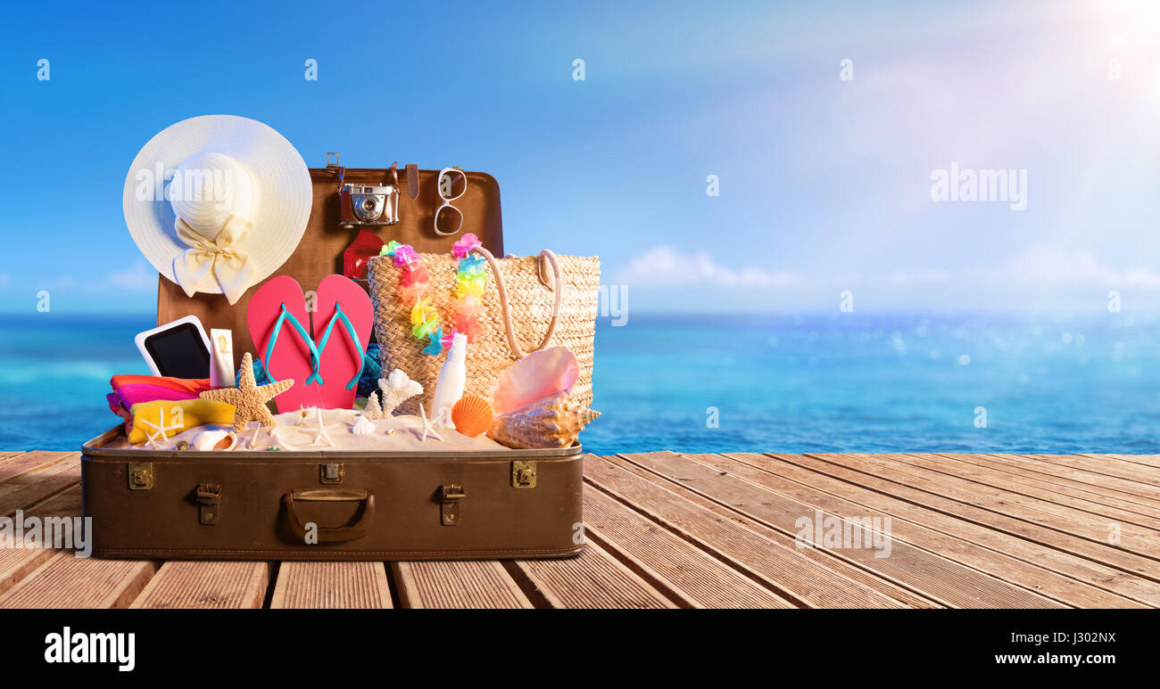Beach Accessories In Suitcase On Beach - Travel Concept Stock Photo