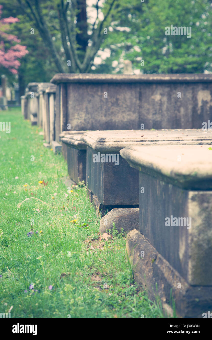 Very old stone crypts are seen in a pre Revolutionary War cemetery. Stock Photo