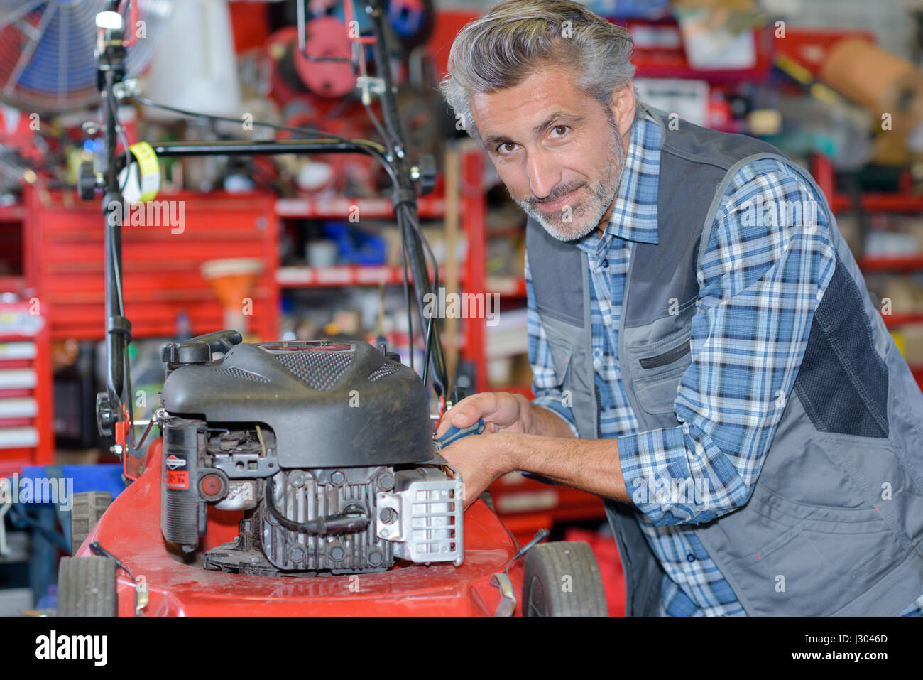 fixing a lawn mower Stock Photo Alamy