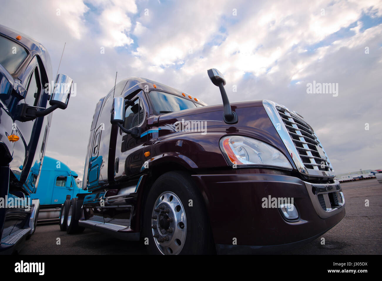 Modern big rigs semi trucks without trailers only tractors on sludge on