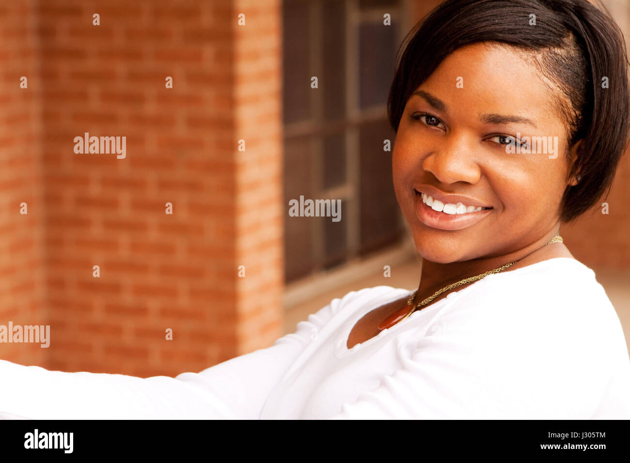 Beautiful young African American woman smiling Stock Photo - Alamy