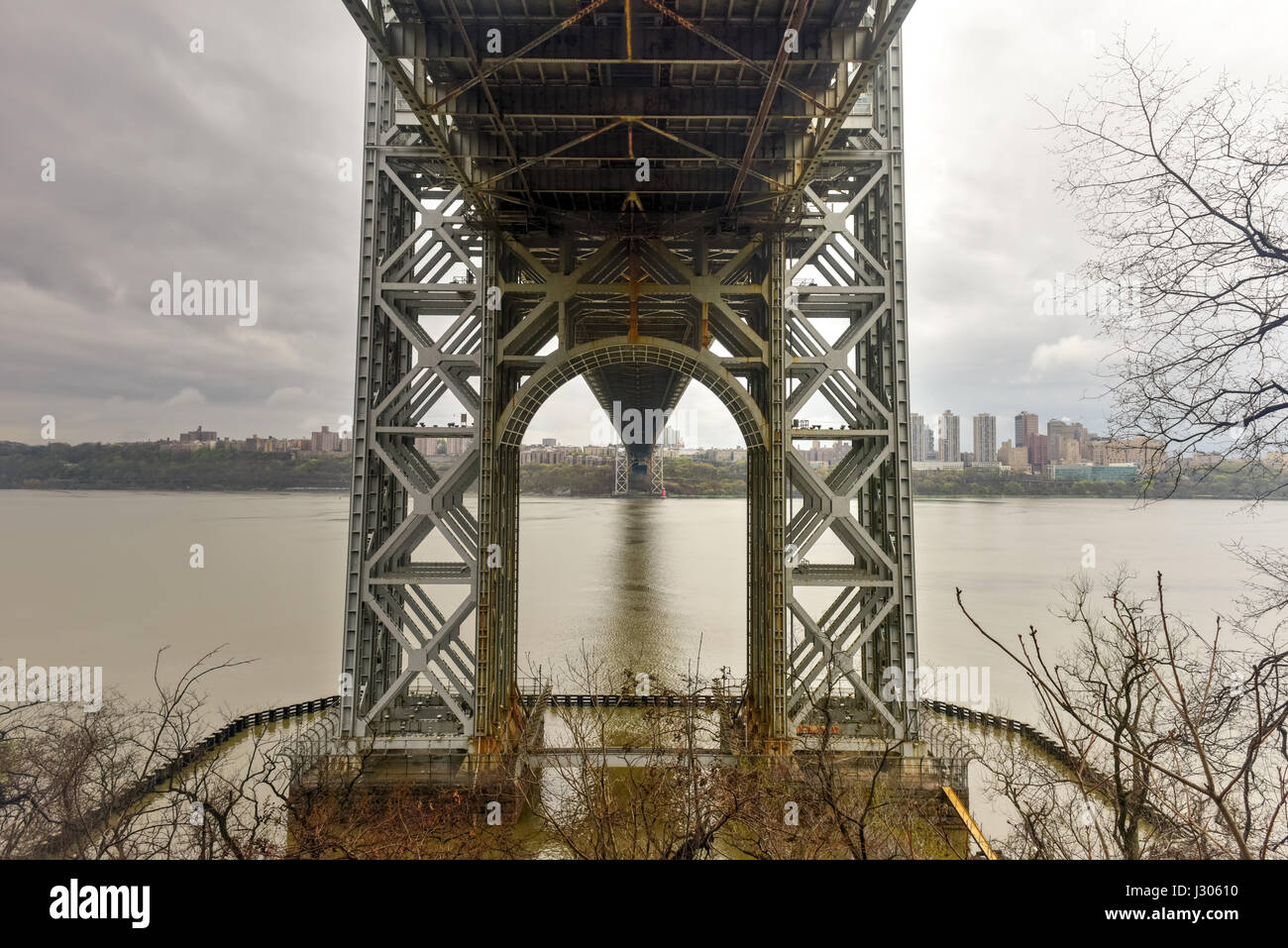 Underside of the George Washington Bridge crossing the Hudson River on a overcast cloudy day from Fort Lee, New Jersey. Stock Photo