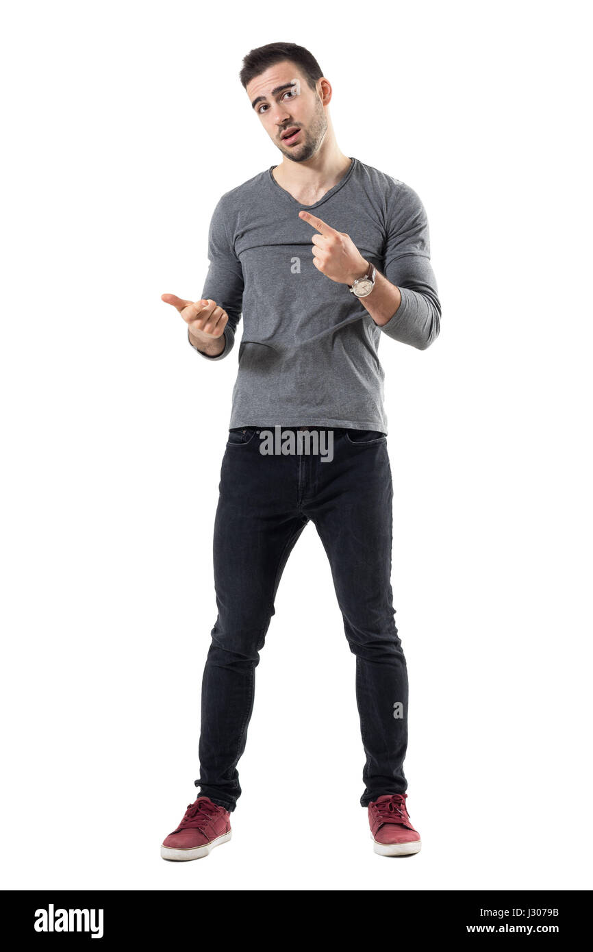 Expressive young casual man explaining and gesticulating with hands. Full body length portrait isolated over white studio background. Stock Photo