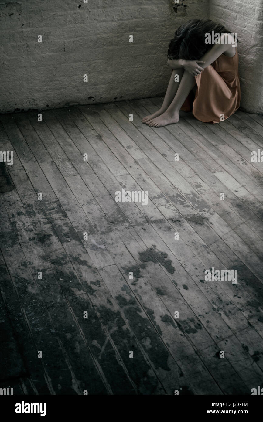 Depressed young woman sat on floor Stock Photo - Alamy