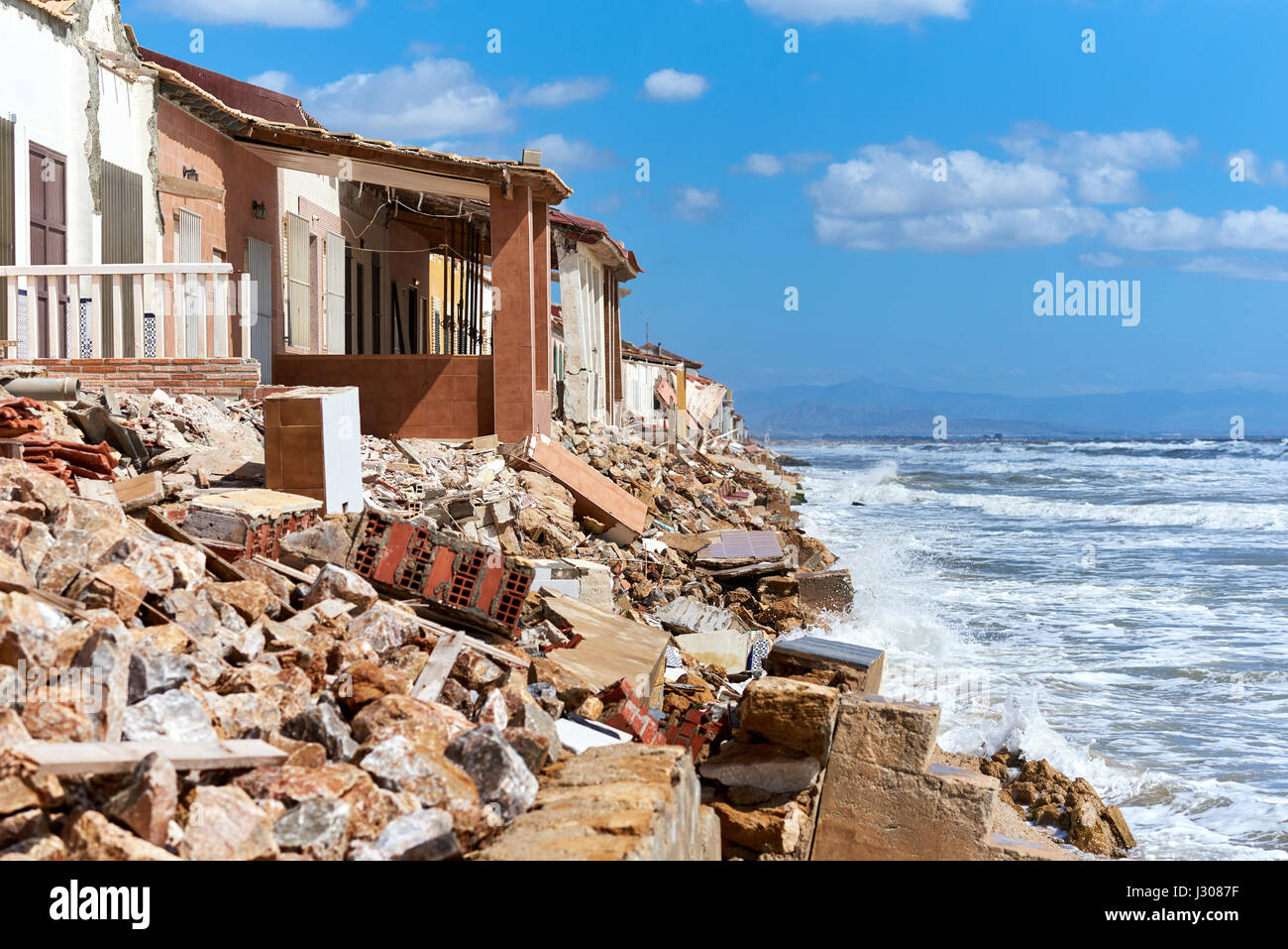 Damaged beach houses. The wind and waves is washed away the beach houses on the Babilonia beach. Guardamar del Segura. Province of Alicante. Spain Stock Photo