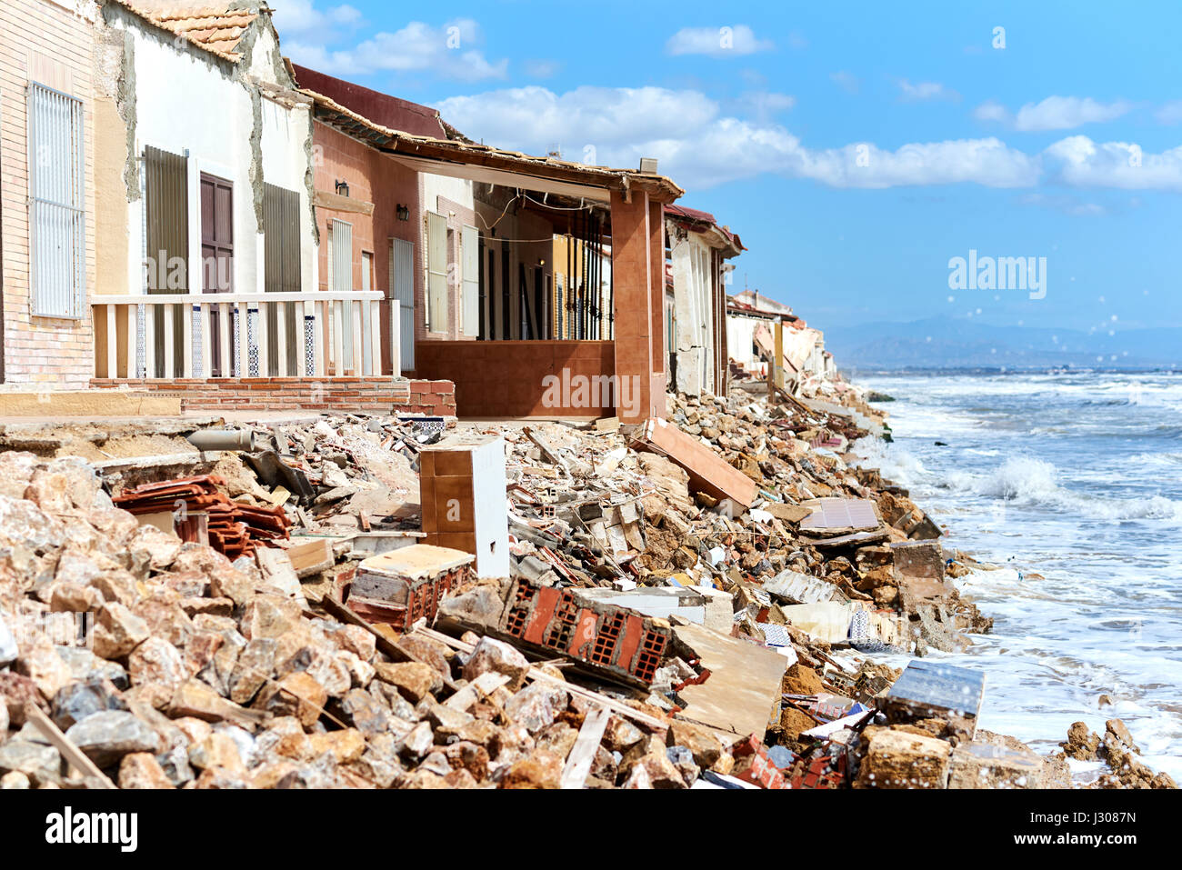 Damaged beach houses. The wind and waves is washed away the beach houses on the Babilonia beach. Guardamar del Segura. Province of Alicante. Spain Stock Photo