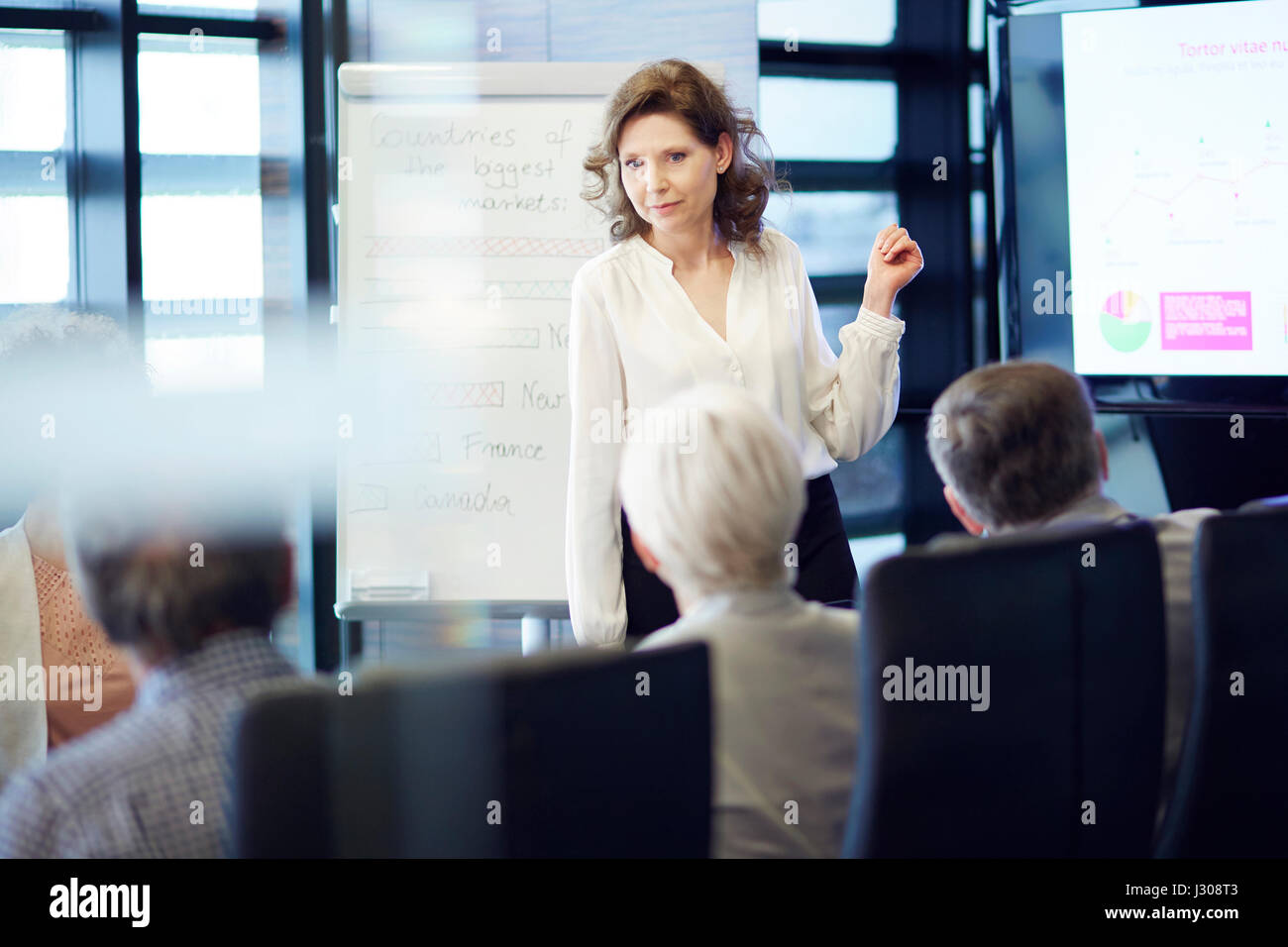 Business woman cooperating with crowd Stock Photo