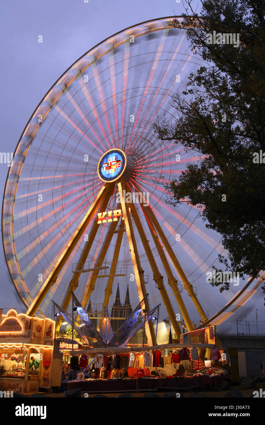 Germany, Cologne, ferris wheel on a kermis in the district Deutz, view to the cathedral. Stock Photo
