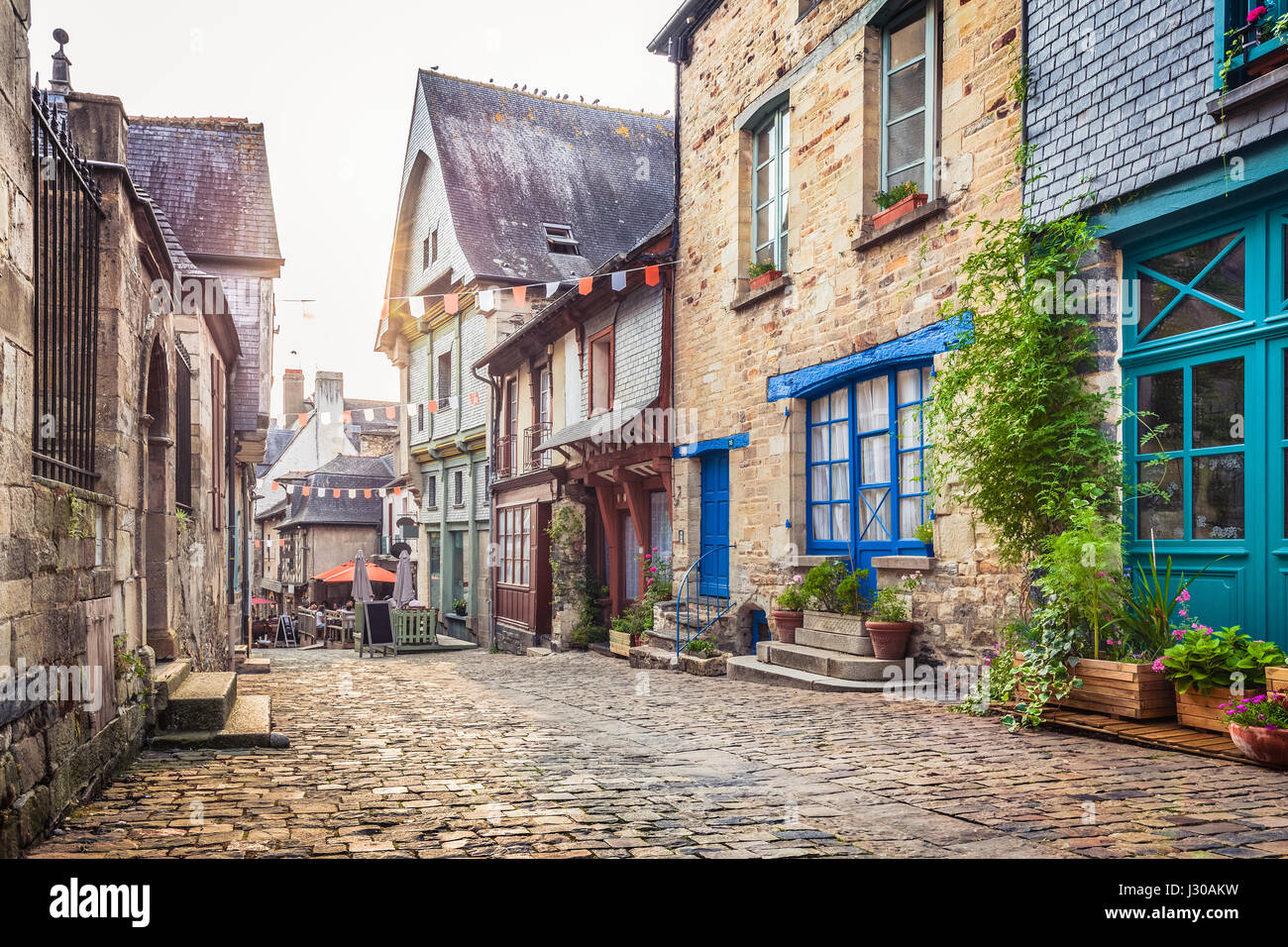 Panoramic view of a charming street scene in an old town in Europe in beautiful evening light at sunset with retro vintage Instagram style filter Stock Photo