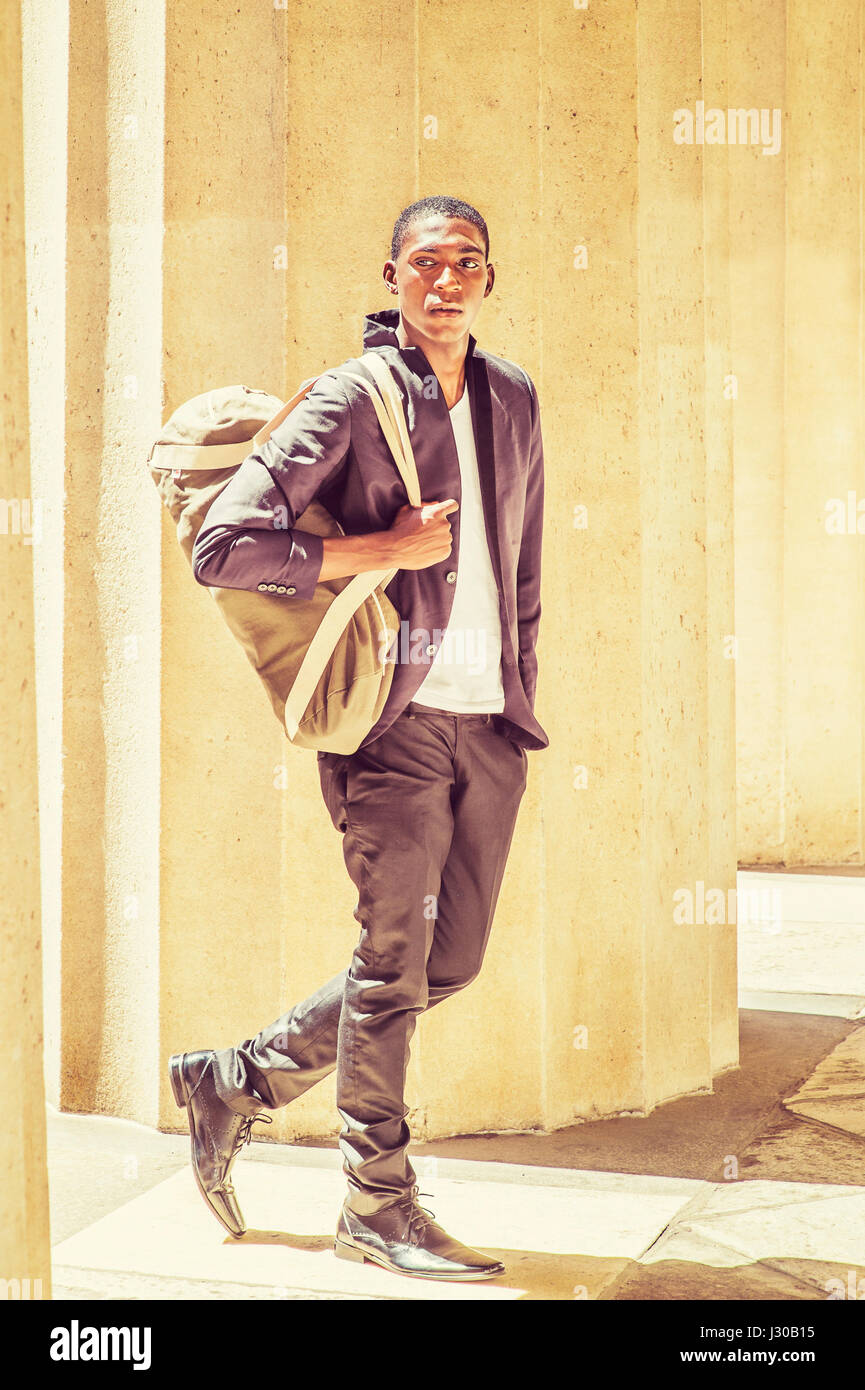 Young black african man walking hi-res stock photography and images - Alamy
