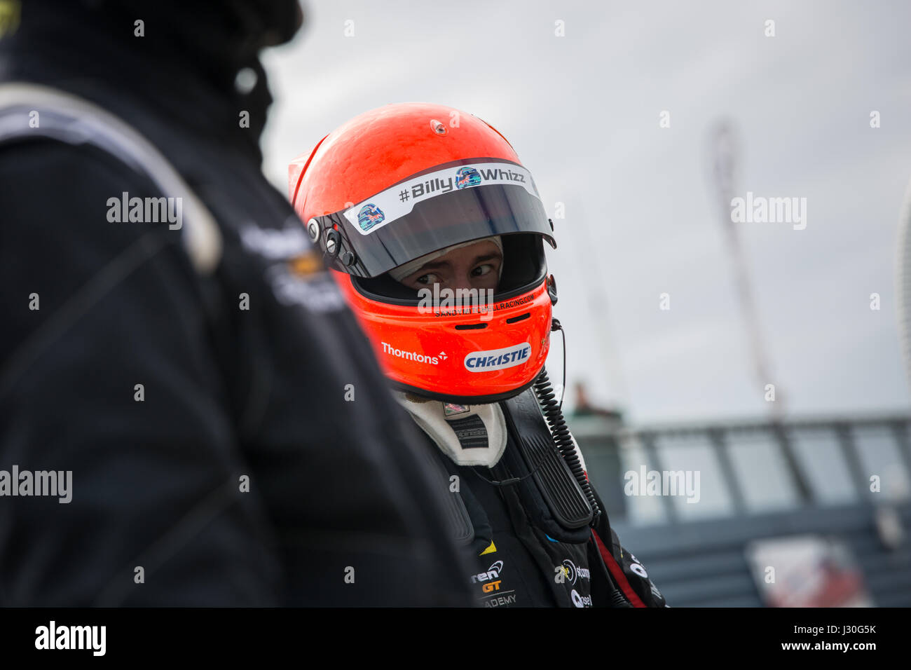 Sandy Mitchell in pit lane waiting to do a driver change at Rockingham Speedway during British GT Stock Photo