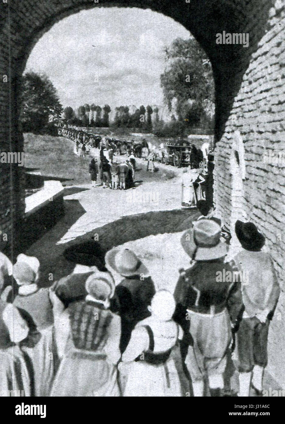'Kermesse arrivo-spagnoli' translates to 'Fete Arrival-Spaniards,' depicting a scene where Spanish individuals arrive at a local festival. It reflects cultural interactions and festivities, possibly from a historical or artistic depiction. Stock Photo