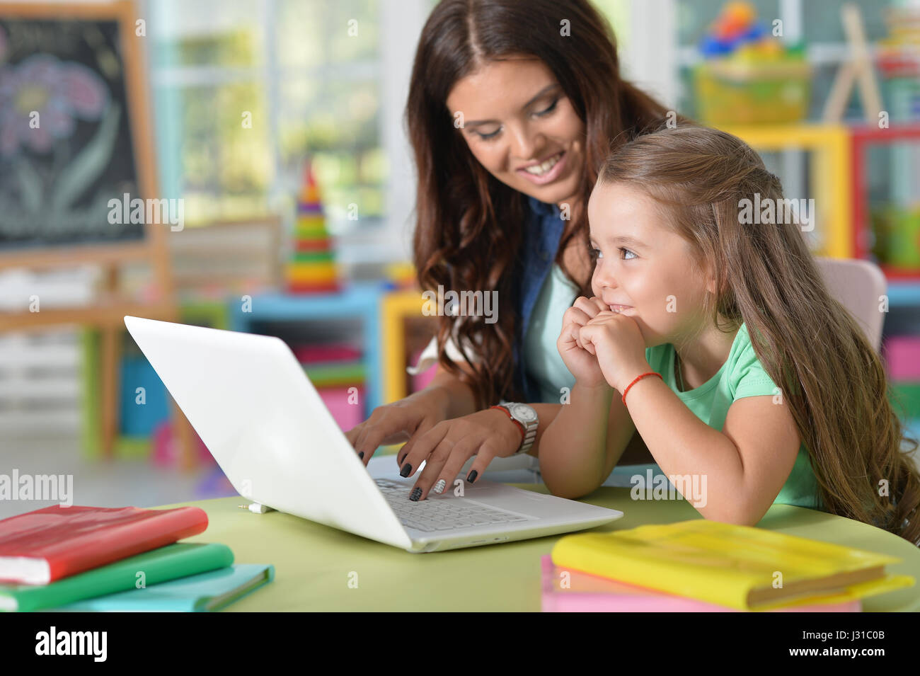 mother and daughter using laptop Stock Photo - Alamy