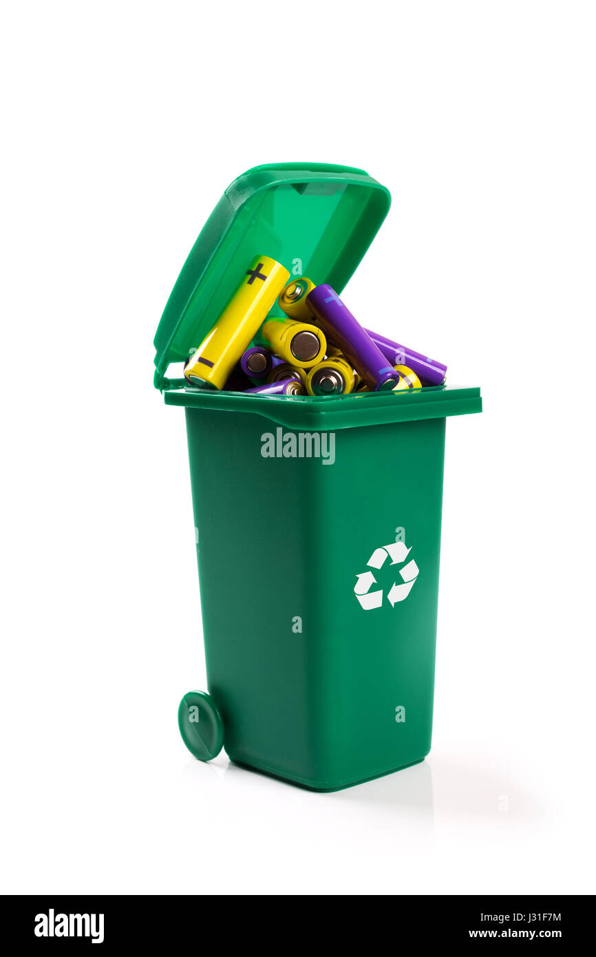 hazardous waste recycling - green wheelie bin full with batteries Stock Photo