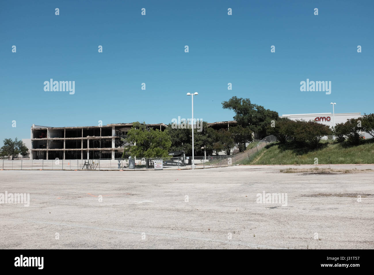 Dallas, Texas USA. 1st May,  2017. Once busy Valley View Mall in North Dallas is shutting down a piece at a time to make room for a new development called 'Midtown'. On the left, the west face of the mall is exposed. On the right, the AMC theater is open for business. credit: Keith Adamek/Alamy Live News Stock Photo