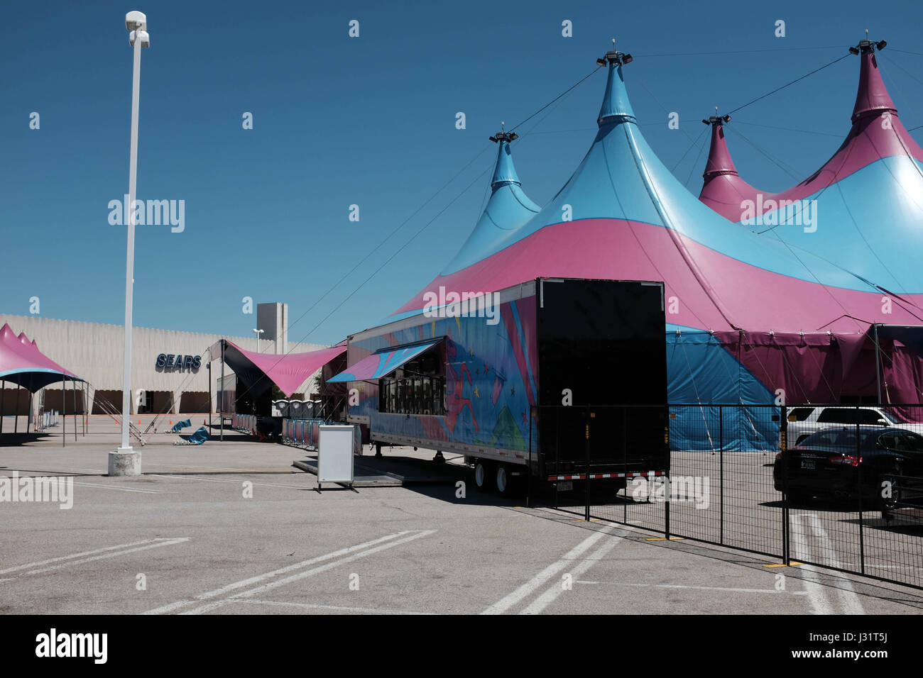 Dallas, Texas USA. 1st May,  2017. Once busy Valley View Mall in North Dallas is shutting down a piece at a time to make room for a new development called 'Midtown'. In the background, a Sears, still open for business, shares its parking lot with a traveling circus. credit: Keith Adamek/Alamy Live News Stock Photo