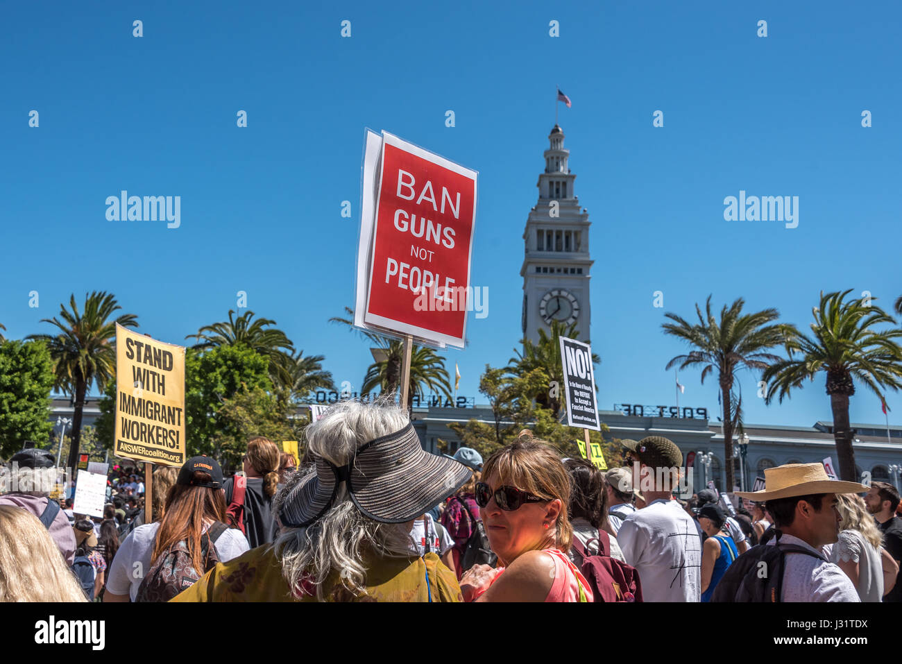 San Francisco, California, USA. 1st May, 2017. Protesters gather at Justin Herman Plaza by the San Francisco Ferry Building for a rally before the 'Day Without Immigrants' march. Thousands marched down Market Street to Civic Center Plaza in the event, protesting Donald Trump's immigration policies. Over forty U.S. cities held similar events on May 1 to coincide with International Workers' Day or May Day. Credit: Shelly Rivoli/Alamy Live News Stock Photo