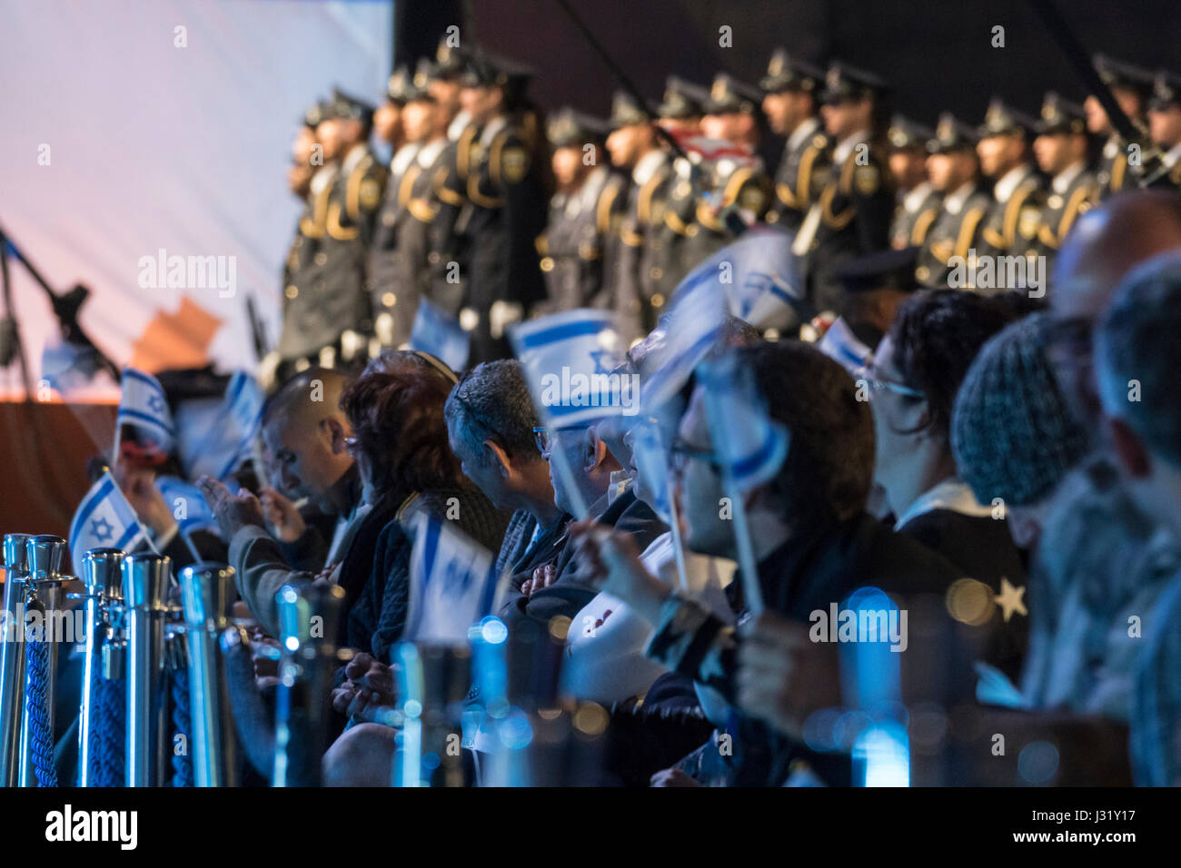 Jerusalem, Israel. 01st May, 2017. Israel's 69th independence day ceremony, mount Hertzl, Jerusalem. People waving Israeli flags while the security guard of the Knesset, the Israeli parliament, forms a guard of honor in the background. Credit: Yagil Henkin/Alamy Live News Stock Photo