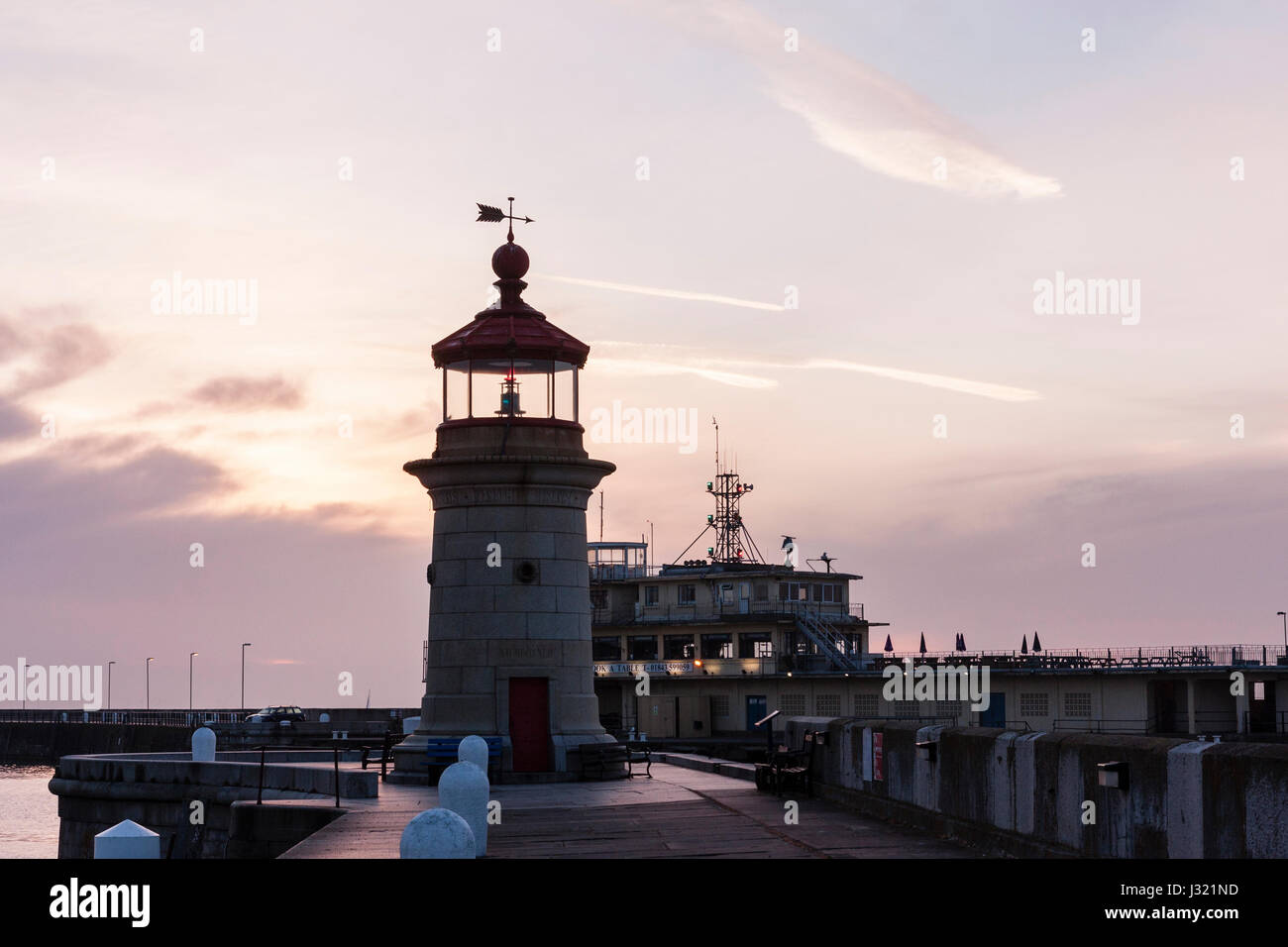 England, Ramsgate harbour. Lighthouse on end of jetty with harbour office behind. Dawn sky with